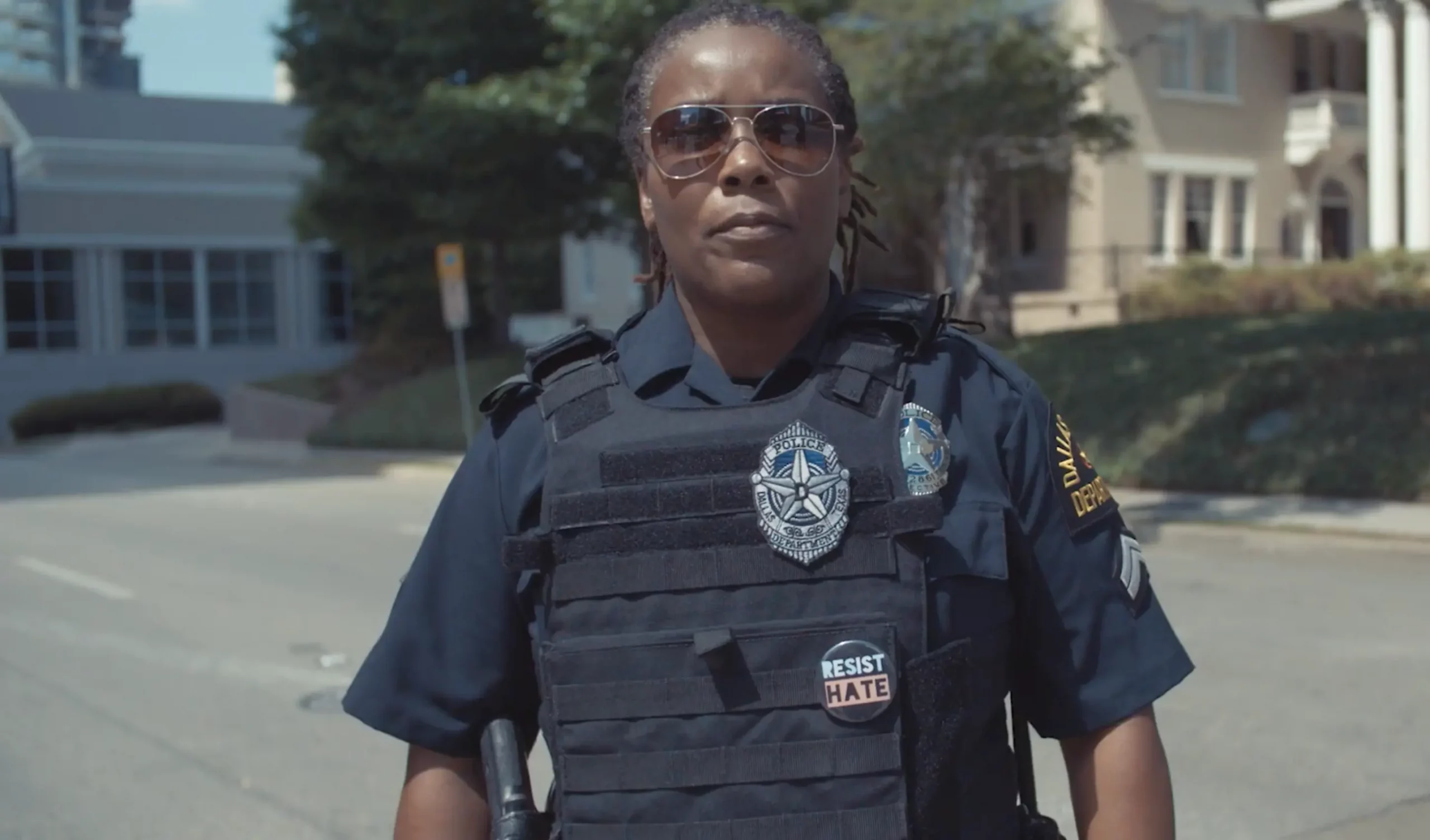 A police officer standing on the street during a photo shoot for a nonprofit video.